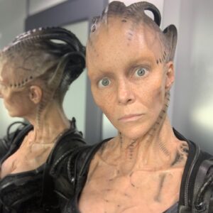 Annie Wersching Instagram - Sick of #Picard posts yet? 
😉👑👽Never, you say?! Great! 
In honor of our panel at @wondercon today, this one goes out to the incredible artists who designed, executed and applied this tricky prosthetic.  In the beginning I was called 4 hours before I was due on set. That included everything…hair in a bun, bald cap, crown on, 10 overlapping prosthetics, airbrushing and hand painting. Then costume and corset and all the rest. We very quickly got the whole shebang down to 2 1/2 hours! I’d go film some snarky BQ scenes and then it would take about 25 mins to remove the makeup pieces. I would let my hubs/family know I was almost finished by sending one of these ridiculous pics of prosthetics being cut off my face! 🤣 Some of my favorite times throughout my whole #StarTrekPicard experience were sitting in the chair being worked on by @jrmackinnon amd @kevinkirkpatrickart. I mean….what talent! And what great humans.❤️@vincentvandykefx and his team created piece after piece and @nevillepage was the concept artist for the whole thing! They did all of this while under the strictest of Covid protocols. I applaud them tremendously and I’m sure they’ll win lots of Emmys. 🏆 As they should! 
Don’t even get me started on @christineclarkdesign and @syzygy_designs and their ridiculously amazing detailed fittings and BQ costume…We’ll save that for next week ;) @startrek @startrekonpplus #picardbts
