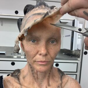 Annie Wersching Instagram - Sick of #Picard posts yet? 
😉👑👽Never, you say?! Great! 
In honor of our panel at @wondercon today, this one goes out to the incredible artists who designed, executed and applied this tricky prosthetic.  In the beginning I was called 4 hours before I was due on set. That included everything…hair in a bun, bald cap, crown on, 10 overlapping prosthetics, airbrushing and hand painting. Then costume and corset and all the rest. We very quickly got the whole shebang down to 2 1/2 hours! I’d go film some snarky BQ scenes and then it would take about 25 mins to remove the makeup pieces. I would let my hubs/family know I was almost finished by sending one of these ridiculous pics of prosthetics being cut off my face! 🤣 Some of my favorite times throughout my whole #StarTrekPicard experience were sitting in the chair being worked on by @jrmackinnon amd @kevinkirkpatrickart. I mean….what talent! And what great humans.❤️@vincentvandykefx and his team created piece after piece and @nevillepage was the concept artist for the whole thing! They did all of this while under the strictest of Covid protocols. I applaud them tremendously and I’m sure they’ll win lots of Emmys. 🏆 As they should! 
Don’t even get me started on @christineclarkdesign and @syzygy_designs and their ridiculously amazing detailed fittings and BQ costume…We’ll save that for next week ;) @startrek @startrekonpplus #picardbts