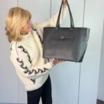 Anthea Turner Instagram - I love Bucket Bags they are my workhorses and they don’t come better than @sarahharanuk well thought out ‘Michelle’ But this one I have here is New Michelle and WOW is she amazing! Especially for someone who wants to stylishly carry the kitchen sink around with her! I’ve been testing her out loads and this weekend while trotting down The Kings Road she held my: Purse Wrap Poo bags Dog treats Lip gloss x 3 - Don’t ask! Keys - attached to internal chain Gloves Phone Emergency fold up bag - made from 8 plastic bottles Notebook Pen AND A few shopping bits and bobs I picked up along the way. I think I’m less likely to loose stuff if I have a good bucket bag to chuck everything into. For extra security you can have the zip version but it’s a personal thing. Massive thumbs up from me and in a basic colour a great investment if old Michelle is anything to go by. Because although smaller, she still looks as good as the first day I used her. #ad