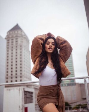 Ariel Yasmine Instagram - It may not be sunny in Miami but blessings still be shining down on me ⛅️ PC: @2kpictures  Coat   Skirt @revolve #revolveme