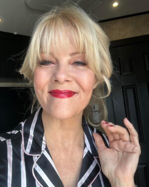 Barbara Niven Instagram - Want to say a quick hi from my trailer door. We’re doing a quick scene change so I have my hair pinned up and then I have to change wardrobe before I go back to set. ￼You know me, I love red lips and nails. It’s a beautiful day in Vancouver! ￼I hope it is where￼ you are too!! ❤️
