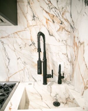 Breegan Jane Instagram - If you watched yesterday’s reel, you know I adore a touch of metallics in a space. You also know I’m a fan of mixing hardware finishes and colors. This is a perfect example of that! Though this space has brass accents, I love this faucet in black and the way it plays so well against the stone with those complementing shades. If you’re not ready to commit to full on black, consider a darker bronze. It will give you the same richness and contrast. Either way, have fun with accents and combine colors for a custom appeal.
