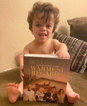 Briana Renee Instagram - My copy of “Best Wishes Warmest Regards” by @instadanjlevy & Eugene Levy arrived today, and Maverick has claimed it as his own😍 He has been “reading” each page, and loves it almost as much as I love the show 👉🏻 @schittscreek 💜 Thank you Dan & Eugene Levy for creating the perfect series #schittscreek #bestshowever