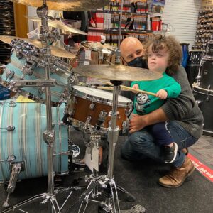 Briana Renee Instagram - Happy Valen-time’s with my handsome Valentine’s 💙🤘🏻 How we celebrate : Go to @guitarcenter, buy a drum set for my most deserving hubby, eat some pizza (him) and a sandwich (moi); then enjoy the night with drum play and snuggles 💙 Maverick has found his “spark” 🥁 #happyvalentinesday #Manningstyle #myhandsomes #truelove #letsmakemusictogether #musical #therealreasonifellinlovewithhim 😘