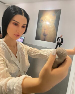 Carlota Guerrero Instagram - “Sofia Willendorf”
Silicon, hair and clay (2022) @staatsgaleriestuttgart #carlotaguerrero 

“An apparent visitor stands serenely in a corner of the exhibition room. She has her back turned to the rest of the viewers and looks down towards a small figurine she holds with one of her hands. 

Titled Sofia Willendorf, the installation takes the historian and anthropologist LeRoy McDermott and Catherine Hodge's thesis from their article Decolonizing Gender: Female Vision in the Upper Paleolithic (1996) as the starting point. In the text, the authors criticize the way the first images of human bodies, the Venus figurines, have generally been interpreted “as sex objects made from a male point of view”. Instead, they argue, they were made by women and for women  as a form of self-representation. Following this, the apparent distortions of the anatomy of the figurines become apt renderings if we consider the body as seen by a woman, presumably pregnant, looking down on herself.
 
Regardless of the veracity of the argument —which seems perfectly logical and credible— the question remains; why did it take so long to consider the logical possibility that a female point of view was involved?
 
Sofia Willendorf gives voice to that pregnant woman in the contemporary context, where past and present archetypes are confronted under the veil of an imposed male gaze the artist tries to subvert. A certain discomfort emerges while staring at the duo, ironically separated by 30,000 years gap. Originally purchased as a sex doll manufactured in China, the contemporary visitor cheerlessly exemplifies both the prevalence and the profound influence of the patriarchy."

text and curation
@marionavaldestorrella
