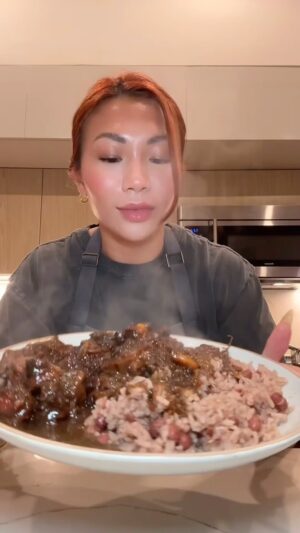 Cassie Yeung Instagram - Left Jamaica and needed oxtail immediately 

Recipe ⬇️ this is how I made it but I am in no way trying to call this authentic 🫶🏻🇯🇲

3lbs oxtail
1 green bell pepper, diced
1 orange bell pepper, diced
1/2 yellow onion, diced
2 green onions
1 scotch bonnet or habanero, seeds removed & diced 
1 Tbsp garlic, minced
1 Tbsp ginger, minced
4-5 sprigs fresh thyme 
1 Tbsp garlic powder
1 Tbsp onion powder
1 tsp adobo 
1 tsp allspice 
Salt & pepper to taste
1 Tbsp browning sauce
2 Tbsp soy sauce
2 Tbsp brown sugar
4 cups beef broth or water 
2-3 bay leaves
Whole scotch bonnet or habanero
1 can butter beans
1 Tbsp ketchup

Clean oxtail with vinegar, lime and water a few times until water is no longer scummy then dry well with paper towel. Add dry seasoning, browning, soy sauce, peppers, garlic ginger and thyme then mix well. Marinate in the fridge overnight or at least 4 hrs. 

To a large pot, add brown sugar and caramelize. Sear oxtail pieces until they have a nice color (you may need to do this in a few batches so all the pieces touch the bottom of the pan). Remove to a clean plate. Add the veggies and marinade left behind and sauté a few minutes. Add in beef broth or water making sure to scrape the bottoms of the pan. Bring to a boil then add oxtail back in along with bay leaves and scotch bonnet/habanero. Turn the heat down to medium low, cover slightly and cook for 3 hrs or until meat is fall off the bone tender. Add in a can of strained butter beans, ketchup and cook for just another few minutes. Serve with rice and peas ❤️
