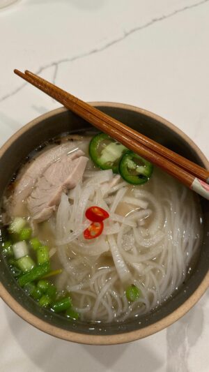 Cassie Yeung Instagram - Annual leftover thanksgiving turkey pho in 45 minutes 🍜

Recipe ⬇️
1 turkey carcass
1 medium onion
1 knob ginger 
Pho spice mix (1/2 pack depending on the size)
5 quarts water
1/4 cup fish sauce
1 small piece rock sugar 

Chili vinegar onions
1 onion sliced
2 Birds Eye chili 
1/2 cup vinegar
1/2 cup boiling water
1 tsp sugar

Roast your onion and ginger under a broiler until they are slightly charred. Toast your spice mix in a pan until they are fragrant and have some color then add to a spice bag. To a large stock pot or pressure cooker, add your turkey carcass, aromatics, spice bag, water, fish sauce and rock sugar. If you are making this on a stove top, bring to a boil then reduce to a simmer for 45 minutes. Serve with rice noodles and whatever fixings you enjoy.