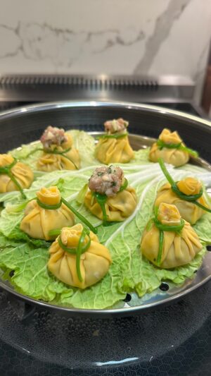 Cassie Yeung Instagram - Money Bag Dumplings 💰🥟

Making these for Lunar New Year— dumplings symbolize prosperity and good fortune 🧧
ALSO perfect if you have a hard time pleating dumplings

Recipe⬇️
2 cups napa cabbage (salted, massaged & washed to release moisture)
1lb ground pork (or any ground protein)
1/4 cup shiitake mushrooms, minced
2 green onions
1/4 cup cilantro
1 Tbsp grated ginger 
1 Tbsp grated garlic
1 tsp Chicken bouillon
Salt & white pepper to taste
1 tsp sugar
1 tbsp Cornstarch
3 tbsp soy
2 tbsp rice vinegar
1 tbsp Oyster sauce
1 tsp sesame oil
Hong Kong style dumpling wrappers
Cilantro stems for tying