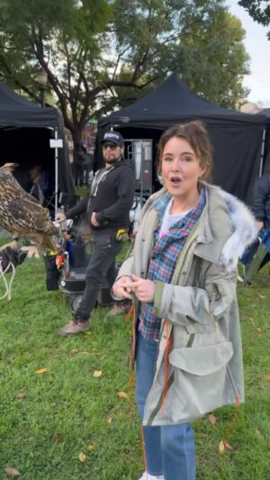 Christa Miller Instagram - Introducing #Shrinking Season 2’s newest crew member, Lowell the owl! Fun fact, parts of LA are filled with wild green parrots who typically have a lot to say, which can make filming difficult. Lowell here keeps the parrots away so that we can film in peace! 🦜 💛🦉 

@greglauren 
@jenmeyerjewelry
