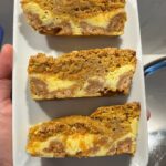 Christina Tosi Instagram – #bakeclub Gooey Carrot Bars, part two: the GOO

Get the recipe here and at christinatosi.com 

Bake Club: Gooey Carrot Cake Bars
Makes 9 squares (or more! Depending on how you cut)

Cinnamon Crumbs
4 tablespoons butter, melted
3 tablespoons sugar
3 tablespoons light brown sugar

½ cup   1 tablespoon flour 
¾ teaspoon cinnamon
¼  teaspoon salt

Heat oven to 325F. In a small bowl, toss butter and sugars together until smooth. Stir in dry ingredients and mix until small clusters form. Spread clusters evenly on a greased sheetpan and bake at 325F for 20 minutes. Cool completely

Cheesecake Filling
6 ounces cream cheese
½ cup sugar

1 ea egg yolk
½ teaspoon vanilla
Pinch salt

Heat oven to 350F. Grease am 8×8-inch baking pan and set aside.
In a small bowl, mix cream cheese and sugar together until stiff and smooth. Mix in egg yolk, vanilla and salt until smooth and fluid. 
Sprinkle ¾ of the cooled cinnamon crumbs across the bottom of the greased baking pan to cover the surface (reserving the remaining ¼ cup for later). Spread the cheesecake filling atop the surface of cinnamon crumbs. Set aside.

Carrot Cake Filling
1 stick butter, melted
½ cup sugar
½ cup light brown sugar

1 ea egg

1 cup flour
¾ teaspoon salt
¾ teaspoon cinnamon
¼ teaspoon baking powder
¼ teaspoon baking soda

1 cup finely shredded carrots (1 large carrot)

In a medium bowl, mix butter and sugars together and stir until smooth. Add egg and mix until smooth. Add dry ingredients and mix just to combine. Stir in finely shredded carrots stirring as little as possible. Spread the carrot cake filling evenly atop the cheesecake layer. Sprinkle the remaining ¼ cup of cinnamon crumbs atop.
Bake at 350F for 40-45 minutes or until the bars puff and caramelize at the edges, remaining slightly jiggly in the center, they are meant to be gooey, afterall!
Cool completely before slicing into 3 rows of 3.