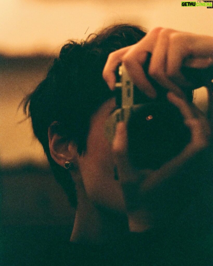 Conor Leslie Instagram - a grainy February self portrait featuring vintage earrings my mother gave me. 35mm •Pentax k1000• cinestill 400D color film• For my film nerds who always ask: it’s on an 85mm lens which is actually my favorite lens as it allows me to do portraits and also capture street photography moments up close while being far away. 🤍🎞️