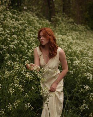 Courtney Halverson Instagram - “I always prefer wildflowers.” 
“I suspected as much.” 💐 

My love of wildflowers and of spring and Jane Austen and romance and Beatrix Potter and The Secret Garden and of antiques and of film scores and far too many other things to name all stems (pun intended) from my mother who raised me with all of the above. Thank you for instilling in me a love of all of this so early on. I am who I am this day because of you. 

And if you happen to recognize the quote here you very likely are similar, so maybe we grew up loving the same things. 🌿
.
.
.
#romanticstyle #cinematicmoments #wildflowers #ialwayspreferwildflowers #vintagevibes 
.
.
Wearing a dress from @rixo paired with beautiful clips from @eponavalley 🌿 lip color is banquette from @iliabeauty