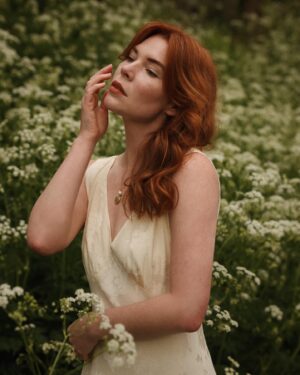 Courtney Halverson Instagram - “I always prefer wildflowers.” 
“I suspected as much.” 💐 

My love of wildflowers and of spring and Jane Austen and romance and Beatrix Potter and The Secret Garden and of antiques and of film scores and far too many other things to name all stems (pun intended) from my mother who raised me with all of the above. Thank you for instilling in me a love of all of this so early on. I am who I am this day because of you. 

And if you happen to recognize the quote here you very likely are similar, so maybe we grew up loving the same things. 🌿
.
.
.
#romanticstyle #cinematicmoments #wildflowers #ialwayspreferwildflowers #vintagevibes 
.
.
Wearing a dress from @rixo paired with beautiful clips from @eponavalley 🌿 lip color is banquette from @iliabeauty
