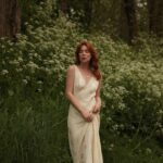Courtney Halverson Instagram - “I always prefer wildflowers.” “I suspected as much.” 💐 My love of wildflowers and of spring and Jane Austen and romance and Beatrix Potter and The Secret Garden and of antiques and of film scores and far too many other things to name all stems (pun intended) from my mother who raised me with all of the above. Thank you for instilling in me a love of all of this so early on. I am who I am this day because of you. And if you happen to recognize the quote here you very likely are similar, so maybe we grew up loving the same things. 🌿 . . . #romanticstyle #cinematicmoments #wildflowers #ialwayspreferwildflowers #vintagevibes . . Wearing a dress from @rixo paired with beautiful clips from @eponavalley 🌿 lip color is banquette from @iliabeauty