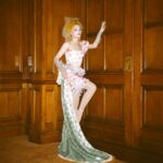 Dakota Schiffer Instagram - 006: The Mane Event, Love your hair hope you win! “curtain call” wig- @wigchapel film- @llyr.evans dress- @ros.ette embellishment- @4bihaywood and myself! This look is so special to me. My twin and I had our femininity policed massively growing up and had all our “girl” toys taken from us along with being told to change the way we talked walked and dressed by our family. After this our Grandma, who used to sneak dolls for us from the charity shop she worked at, let us play with the curtain tassels in her house and pretend that they were our hair. She never questioned our femininity and was one of the first family members who let us know it was ok to be feminine so to turn it around into a look was very emotional for me! This look is a love letter to anyone who had their femininity policed growing up. Even when we were being actively taught to be ashamed of the way we were naturally, it’s small moments like this from childhood that really stick with you. I know it’s silly but wearing curtain tassels on my head again was a very full circle moment! Reclaiming that femininity was so important for me to represent and I’d like to thank our Grandma for letting us be ourselves growing up! (and for also not getting angry at us when we took scissors to her curtain tassels!) 💖💖💖