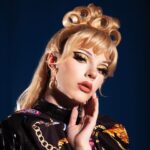 Dakota Schiffer Instagram - 005: Design Challenge, Cohesive High Fashion looks photo- @gregbaileyphoto inspo- @versace & @richardquinn hair- me! This win was so important to me! A Versace meets Richard Quinn fusion was the idea within about 5 mins and @bby.ldn was the best teammate I could’ve asked for! From Baby talking me through a meltdown after trying to make leggings for 3 hours, me whipping this dress together pretty much after filming confessionals in the morning, styling both our wigs at 5am before we got the coach to the studio and hot gluing bows to each other 3 mins before the runway, this challenge was chaos but I wouldn’t change it for the world! I also wanted to wait till this episode to say that I really struggled to keep up financially with my runways. I’ve seen a fair bit of criticism towards my “simple” aesthetic, which I think is a combination of financial constraints, the extremely high standard of queens this season and getting many of my fashion references from runways and less “draggy” aesthetics. It sucks because I would’ve loved to bring my grandest ideas to life but it wasn’t possible for many runways. It wasn’t in the episode but i remember saying in confessionals “take everyone’s wallets away, and I’ll come out on top”. Winning the design challenge as a self proclaimed fashion queen after week one felt like the perfect redemption! Thank you for all the love and support 🖤💛🖤 Also go check out signed prints of these looks @gregbaileyphoto link in their bio!