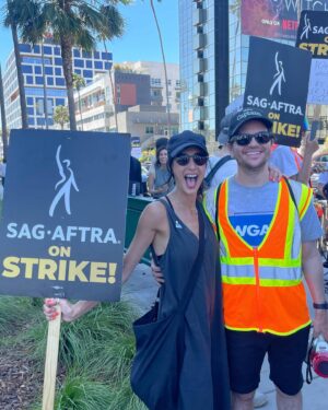 Dana DeLorenzo Instagram - Striking on Sunset Blvd today w/ #WGA pal @afatliberal. Very serious at first. But after we kept getting a cacophony of nonstop support from cars I couldn’t stop smiling — everybody FIRED UP! So happy to see my buddy @agioe speaking at the end rally! Thanks to all the volunteers and especially the wonderful ladies who hydrated us w/ the best damn homemade iced tea on the planet. 
But make no mistake: this is a really fkn scary and difficult time. But it’s vital. 
As long as it takes!

#sagaftra #sagaftrastrong #sagaftrastrike #wgastrike #wgasolidarity #power2performers