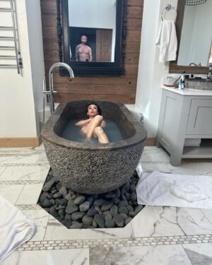 Danielle Harris Instagram - Reality Check! This may look like an IG planned photo, but ya wanna know what was really happening?😂……. David was getting dressed for dinner and I was looking at the ceiling asking  if he could build me ceiling wood slats in our bedroom like the hotel we were at, so he came in to take a pic of what the hell I was talking about and apparently NOT taking the photo of the ceiling 😂 lol @gstafford I LOVE baths and this tub was EPIC! @camplucyoncreek #renovation #buildit #sneaky #anniversary #wife #pinterest