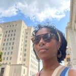 DeWanda Wise Instagram - Lately. {De outside in a cute striped dress, shades, and earrings with her septum piercing in. Bywater. A sign reads, “Beware of Ghosts.” My skincare routine is water, sunscreen, and minding the business that minds me. Pizza that’s hilariously large to be on the kids menu. A long hallway with her dog.}