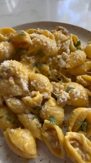 Dina Deleasa Instagram - The most hearty pumpkin pasta to warm your bellies this season. The loose recipe is below. The crumbled browned pork and sage add a little extra heartiness and flavor to the dish.  Make sure to taste along the way to adjust the seasoning. I even sprinkled a bit of red pepper and more Parmesan cheese when serving this dish ! And don’t forget to save that pasta water!

1lb medium pasta shells
1 tbsp olive oil
1lb ground pork
1 tbsp kosher salt, plus ½ tsp
1/4 tsp pepper
2 tbsp unsalted butter
3 tbsp finely chopped garlic
4-5 sage leaves
1/4 cup dry sherry
1 cup pumpkin puree
3/4 cup heavy cream
¼ tsp ground nutmeg
1 tsp lemon juice
¾ cup shredded mozzarella cheese
¼ cup grated Parmesan Cheese
 
1. Bring a large pot of water to a boil, add 1 tbsp kosher salt. Cook pasta until al dente, according to package instructions, reserve ½ cup pasta water before draining.
1.Heat olive oil over medium heat in a large skillet with high sides.
2.Brown the pork, breaking it up into small pieces, season with salt and pepper, moving around the pan periodically, about 10 minutes.
3. Remove the ground pork from the pan with a slotted spoon
4. Add butter to the pan, once melted add garlic and sage leaves, saute for 2 minutes.
5. Add in the sherry, scrape up any brown bits, bring sherry to a simmer for 2 minutes.
6. Then add in pumpkin puree whisking gently to incorporate.
7. Add cream, pasta water, and nutmeg, whisking gently again until uniform. Let simmer for 3 minutes.
8. Season with salt and pepper to taste, add lemon juice
9. Remove from heat, add in the pasta and toss gently to coat.
10. Add in both the Parmesan and mozzarella cheese, tossing gently. Serve immediately!