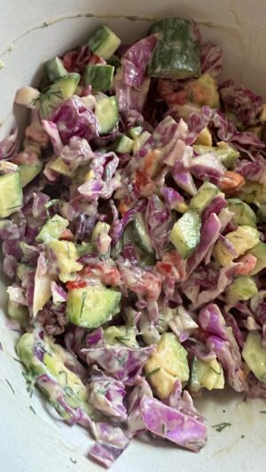 Dina Deleasa Instagram - This video is just as messy as this salad! I am not always, actually most likely, not standing in my kitchen with my hair blown out, with my best Amazon linked outfit. Although I do wonder why my apron has such a weird top now that I look at it. I figured let me just show you what I’m eating for lunch and get over it if you see my cutting board dirty, my actual measuring cup, not my anthropology prep bowls. Although I do love those! 

Just because this reel doesn’t have the elements to go viral doesn’t mean this recipe isn’t delicious. Just because you saw my measuring cup and I ate from spatula in my messy kitchen doesn’t make me less of person, haha! And same goes for you. Sometimes you are going to nail that effortless outfit vibe, you may finally get your living room to look like a white& beige museum, celebrate that. But sometimes it’s just not that way, and it doesn’t mean you aren’t worth it , your home isn’t worth having people gather, don’t get on that thought train !

Now chop up a bunch of red cabbage, dice up a cucumber and an avocado. And pour this dressing over top. Don’t forget to give it a hit of balsamic vinegar! And maybe next video ill be a little more put together for ya !

1/2 cup plain Greek yogurt 
1/4 cup honey
3 tbsp Dijon mustard
2 tbsp olive oil
1/2 cup chopped roasted red peppers, drained
1 tbsp fresh dill, chopped
1 tsp kosher salt 
1/2 tsp onion powder
1/2 tsp red pepper flakes 
1/2 tsp black pepper 

Add ingredients to a bowl, whisk together vigorously until well combined , pour desired amount over salad. Also makes a great veggie dip!

#dishitgirl #atthekitchensink #mommoments #saladrecipe #quicklunch #easyrecipe #veggierecipes #healthyrecipe #crunchysalad #encouragingwords #notaninstamom
