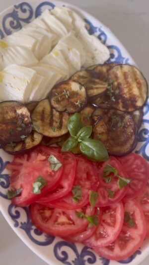 Dina Deleasa Instagram - Instant elevation right here ! Just take a couple of minutes to grill up some eggplant rounds and put them on the platter with your tomato and fresh mozzarella!

I throw some olive oil on a grill pan and grill the rounds for about 2 1/2 minutes on each side. As they grill I sprinkle them with kosher salt , give the a drizzle of honey and a tiny splash of balsamic . Then I flip them over . 

I hope everyone enjoying the long weekend and taking a moment to be grateful for those who have worked to ensure we have the freedom to gather and celebrate!

#eggplant #hardcoreitalians #dishitgirl #caperesesalad #tomatomozzarella #summersalad #summerentertaining