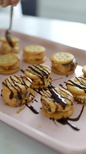 Dina Deleasa Instagram - #AD Sponsored by RITZ. All thoughts and opinions are my own. Mini @ritzcrackers Ice Cream Sandwiches are sure to be your favorite new fall treat! Complete with Pumpkin Ice Cream and Hazelnut Chocolate Swirl, these mini bites sound fancy but are super easy to make. Plus, you can find all of the ingredients at your local @walmart This recipe is no-churn, and all you need is a toothpick to swirl the chocolate hazelnut spread through the pumpkin mixture. After a couple of hours in the freezer, sandwich small scoops with a melon baller in-between the RITZ Crackers, pop them back in the freezer to firm up a bit and they are ready to go! The buttery rich taste of the RITZ Crackers pair perfectly with the pumpkin and chocolate flavors of the ice cream. These mini sandwiches are the perfect treats for after sports games or a day of fall fun activities! Grab the recipe below #RITZCrackers #tasteofwelcome
 
14 oz can sweetened condensed milk
15 oz can pumpkin puree
1 tsp vanilla extract
¼ tsp cinnamon
1/8 tsp nutmeg
2 cups heavy cream
2 tbsp confectioners sugar
1 cup chocolate hazelnut spread
40 RITZ Crackers
Yields 20 ice cream sandwiches, with ice cream leftover to enjoy later!
 
1.  Whisk together condensed milk, pumpkin puree, vanilla extract, cinnamon, and nutmeg until well combined.
2.  In another bowl, using an electric hand mixer, beat the heavy cream and confectioners sugar until it forms soft stiff peaks, about 5 minutes
3.  Fold the whipped heavy cream into the pumpkin mixture until well combined
4.  Pour half the mixture into a freezer friendly container, I chose an 8x8 pyrex
5.  Top it with about half of the chocolate hazelnut spread, and using a tooth pick swirl the chocolate throughout the pumpkin mixture
6.  Top with remaining pumpkin mixture, followed by the rest of the chocolate spread, swirling it through the top once again.
7.  Cover and place in the freezer for 4 hours, until firm.
8.  Meanwhile, prepare a large baking sheet with parchment paper.
Recipe continued below 👇