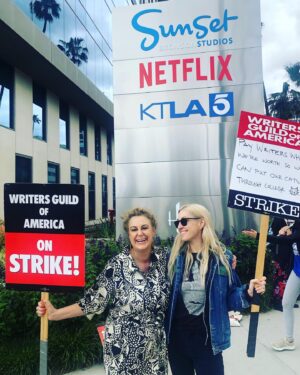 Dylan Meyer Instagram - You may not know this but we (the writers) have struck because The Man is trying to get us down. Without writers, your movies and tv shows will suck. Trust. Our fight for fair wages is so important we’ve been forced to walk around and wave signs about it - and we need your support! If you love stories tell the studios to value the storytellers! #wgastrong writers 4 ever PS doesn’t @kiwilovesyou’s incredible jumpsuit go great w my sign?!?