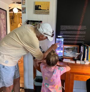 Elizabeth Hendrickson Instagram - It’s no secret that Jimmy Buffett was the best. We are lucky enough to say that we have many memories with him that will remain in our hearts forever. Josephine has been listening to him since she was born and her summer anthem this year was “volcano”. 
Smooth sailing Jimmy, Fins up 🦈