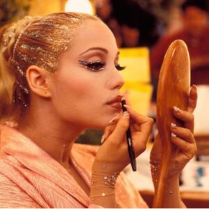 Elizabeth Berkley Instagram - Should I offer overlining lips tutorials ?! 🤣This was a touchup on set with the holy grail @maccosmetics spice liner with a recipe #showgirls makeup artist David Forrest and I concocted. Check the nails and rhinestones everywhere… a girl can never have enough in my opinion. ✨✨ Do you see how this OG makeup influencing makeup on shows like #Euphoria etc now? Love the artistry involved in creating characters through makeup, wardrobe (in this case with the genius @byellenm )and other elements that make you move differently, and hold yourself energetically in new ways. 🎬🎥✨✨✨❤️ 💅🏻💃🏼