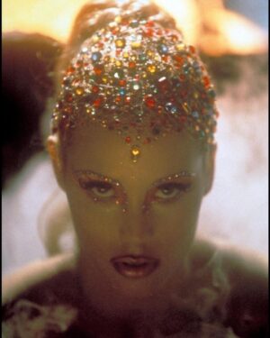Elizabeth Berkley Instagram - Here’s a fun little #fbf and first time #showgirls trivia for you from my personal archives... when we were figuring out the look for #nomimalone for emerging from the volcano (as one does, right?!), this first pic was of course the final filmed look. But if you swipe for the second photo, this was me in the makeup chair exploring another magical headpiece. So happy we went for the multi colored rhinestones tho. What do you think, darlin? 🌈✨✨🌟🌟#imadancer #differentplaces #shejustwentdown #letmedoyournailssometimedarlin💃🏼💃🏼#itsaversayce#hair #hairstyles #hairstyle