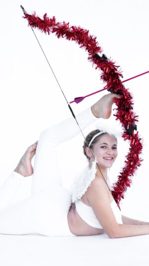 Emerald Gordon Wulf Instagram - Sending love to all of you with this little Valentine’s throwback! Happy Valentine’s Day! Photos by @kalialexsis outfit by @bluewaterdancewear 
#valentines #valentine #cupid #love #sweet #angel #flexible #flexibility #contortion #contortionist #heart #archery #bow #yoga