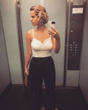Emily Althaus Instagram - An archived photo of your step pep from a time when hair cuts were readily available and he wasn’t “afraid of the elevator”. An effortless finger wave and flirty hips, are just a few of the things us step dads discuss when we’re allowed to be near each other 😔 #tb #elevator