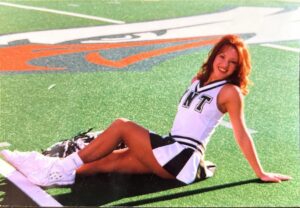 Erin Cummings Instagram - I auditioned for a fantastic new show last week in the role of a former college cheerleader…. It reminded me of this throwback pic from my redhead days as the Captain of the UNT Dancers at the University of North Texas, circa 1998!!

I keep this picture framed on my husband’s nightstand. That way, even when he rolls over and sees his hot mess of a wife - hair in a bun, sleep mask on, night guard in, old t-shirt and granny panties, snuggling with my dog and surrounded by cats - he can look at this picture and know that a hot piece of ass is buried in there somewhere! 😂 

Go Eagles! 🦅 💚💙🤍💙💚 #UNT #NorthTexas