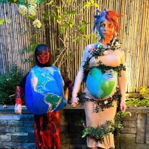 Georgina Bloomberg Instagram - Half underwater, and half on fire, draped in items to represent the many ways I am slowly dying, and topped off with a necklace  made from rope and plastic we picked up from the beach this summer, my version of Mother Earth was an angry one this Halloween. And because there are very few things scarier… I brought my terrifying sidekick Global Warming along for the night. 🌍🔥☠️🌊