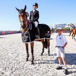 Georgina Bloomberg Instagram - It hasn’t been an easy road back to the winner’s circle. But making it back in on the beach, and with my favorite fan by my side, made it worth every moment. ☀️🌊💙🐴🌴 @longinesglobalchampionstour (📷: @sportfot.photovideo)