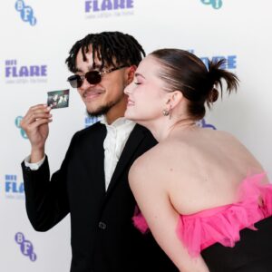 Hallea Jones Instagram - Coco’s manic panic pink hair made its world premiere in WE FORGOT TO BREAK UP at @britishfilminstitute Flare Festival on Sunday! What an honour to have our queer indie Canadian film be presented in the UK at such an iconic queer festival. Truly a week to remember. Thanks so much for having us!! 

Also can we have a moment for the dress?! @spacevintagexo provided YET AGAIN a stellar premiere dress and I’ll be honest I judged HARD when I saw it on the rack but it was such an obvious done deal once I put it on. Coco is GO BIG OR GO HOME with her hot pink hair so I knew I had to honour her with something just as daring on premiere night💞🌸

WE FORGOT TO BREAK UP is premiering in North America soon but where….? That is a secret for now 🤫😏