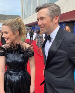 Harriet Dyer Instagram - That time we went to the BAFTAS to present an award and I didn’t open an envelope properly (see previous post). 
Classic Slap Dash Dyer. 
Thanks to Patty for making lemonade up there and holding my sweaty, rubbery hands.
Thanks to @todiscon for making it allll happen and the good people at @paramountgcd and @cbstvstudios for getting us over there. 
The love for Colin over in the UK has been epic and we are grateful to everybody who has watched it. 
Styling : @pennylovellstylist 
Outfit : @houghtonnyc 
HMU / full blown wizardry with my tired-ass, wrangling toddler on a long haul face : @carlafrancesca.mua 
Hair colour and psychologist: @leikerhair 

Slide 1 PA Images / Alamy Stock Photo
Slide 2 Scott Garfitt/ BAFTA via @gettyimages 
Slide 4 photograph by Joe Maher for @gettyimages 

Thanks to the @baftas for having us and @pandocruises for hosting a brilliant evening. 
Probably MOST importantly if anybody is still here, it wasn’t a dress, it was PANTS. 
Thank you for your time.