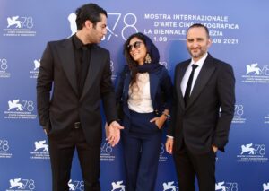 Hoda Zeinolabedin Instagram - نقد ورایتی
آلیسا سیمون

«زالاوا» چرخشی تازه در قراردادهای ژانری

ارسلان امیری که از کردهای ایرانی است در اولین فیلم بلند خود چرخشی تازه را در قراردادهای ژانری ایجاد کرده؛ فیلمی که با لحن طنزآمیز زیرکانۀ خود آهسته به سمت تراژدی می¬رود و در آن باورهای علمی در برابر خرافات قرار می‌گیرند و این موضوعی است که در دنیای امروز طنین قدرتمندی دارد. یکی از بزرگترین نقاط قوت زالاوا، بازی نوید پورفرج، ستارۀ بلندقامت و خوش صورت و سبیلوی داستان در نقش یک استوار ژاندارمری است. در ابتدای فیلم درمی‌یابیم زالاوا یک قرن پیش توسط کولی‌ها بوجود آمده و ساکنین فعلی آن پوست‌هایی لکه‌دار و موهایی سفید دارند و در خواب راه می‌روند. ملیحه (هدی زین‌العابدین) پزشک جذاب خانۀ بهداشت باور دارد دلیل احوالات عجیب غریب اهالی، ترس و باورهای خرافی است. در حالیکه زالاوایی‌ها از حضور جن تازه‌ای در روستا به هراس افتاده‌اند، جن‌گیر دوره‌گردی (پوریا رحیمی‌سام) ادعا می‌کند جن نادیدنی را داخل بطری کرده. امیری و همکاران  فیلمنامه‌نویسش آیدا پناهنده و تهمینه بهرام صحنۀ اولین تقابل استوار و جن‌گیر را چنان جذاب به نگارش درآورده‌اند که کل صحنه تبدیل به یک زورآزمایی چند راندی می‌شود و فاتح این نبرد، استوار است که با بازداشت کردن آمردان باعث خشم اهالی می‌شود. در پاسگاه، دوربین با حرکاتی خاص سینمای وحشت، از یک بطری خالی ترس و دلهره خلق می‌کند. با فرار آمردان و بازگشت استوار به روستا همراه سربازش یونس (با بازی کمدی و عالی باسط رضایی)، نویسندگان استادانه خطر را لحظه به لحظه بیشتر می‌کنند و در دل اینها، یک بخش تأثیرگذار رمانتیک هم بین استوار و ملیحه گذاشته شده است. اما آمردان از راه می‌رسد و حالا تیشه‌ای محکم برای زدن ریشۀ استوار دارد. در حالیکه می‌توان فیلم را به عنوان چیزی نو و تازه در سینمای ژانر ایران مورد تحسین قرار داد، محتوای تمثیلی فیلم بسیار بیش ازین جذاب است. اهریمن می‌تواند استعاره‌ای از بیماری کووید نوزده (کرونا) باشد زیرا که همچنان نبرد بین علم و خرافات در سراسر جهان ادامه دارد. با اینکه فیلم با بودجۀ نسبتاً کمی ساخته شده، دستاوردهای فنی آن قابل ستایش است. موقعیت دوربین در جاده‌های پرپیچ و خم کوهستانی یادآور سینمای کیارستمی است و البته محمد رسولی مدیر فیلمبرداری خوب می‌داند چطور با دوربینش در صحنه‌های ترسناک ما را میخ‌کوب کند. در همین حال تدوین عمادخدابخش و موسیقی فضاساز رامین کوشا هم به حفظ تنش در کل اثر کمک کرده‌اند.