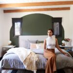Janina Gavankar Instagram - The ceiling used to be painted silver. You can see these beams get shaved down to their natural color in my “house redo” highlight. (I can’t believe I almost did it myself. Thank god @mandychengdesign didn’t let me.) As for this look - I know I present high femme at events, but I feel more at home in a more masculine/gender neutral environ. Probably why the central color of my house is army green. Also, I’ve never had a king bed. We chose this @inmod one Bc it’s modern and can be redressed a billion different ways as I inevitably change my mind about its coverings.