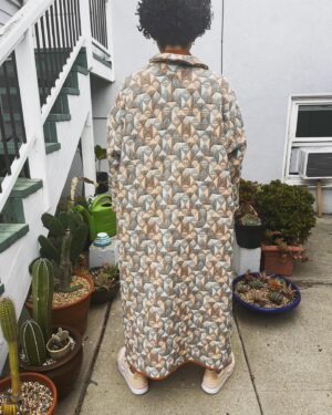 Jasika Nicole Instagram - I didn’t hop onto the quilted jacket trend til @byhandlondon released the #NerrisaCoat pattern a couple months ago. I loved the collar, the oversized fit and the long length, three elements that I had not previously seen in quilted coat patterns, and I had the *perfect* fabric for it- a geometric reversible quilted cotton smack in the middle of my color palette from @corefabrics. The pattern is very simple, pretty beginner friendly, and requires very little fit adjusting because it’s so oversized. I made the smallest size available (it goes up to a size E/ 61.75” bust) but it’s still incredibly roomy, like I could probably fit a sweater AND another coat under this lol. If I were to make it again I would probably slim down the fit by a couple inches and shorten it to shin length, which I might still do, but I wanted to get some wear out of this length before I chopped it up. I opted not to add buttons to the front and just have this be a kind of open jacket for layering. I made the bias binding myself and this is the only issue I had with the pattern- it says you need 5 meters of binding but I easily used 3 times that much for this view (I stopped counting after the third time I had to pull out my tools to make more tape 😵‍💫), so maybe that amount was meant for the shorter version of the jacket (because it doesn’t give different amounts for the different views). Thankfully I had just enough tencel scrap fabric to make all the tape I needed. The bias binding gives the jacket a nice pop of color while still feeling a bit neutral and I love how the colors in the fabric and tape play off of each other. I’m on the fence about the patch pockets on my version and think it would look even better with inset pockets, and because of the bulk of the quilted fabric, the drop sleeves look a little funky at the seams(I prefer inset sleeves). But those design choices are what makes this such a simple and quick pattern to finish, and I’m still happy with how this came out. The fabric is structured but soft and wearing it feels like you’re draped in a blanket cocoon- it actually makes a pretty great housecoat if you’re careful to not trip over it 😂