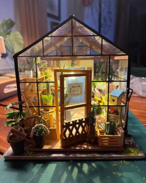Jasika Nicole Instagram - My neighborhood besties @cyndiotteson and @quinnofeaglerock gifted me the cutest diy miniature room kit to put together last year, and I loved it so much I asked for a bigger kit for christmas, and at long last, only 9 months later 🥴, it’s finally done! This kit was like my personal equivalent of a 1,000 piece puzzle (though I’ve never done one so I don’t know how accurate that is). All I know is that it was extremely intense, required so much focus that I felt cross eyed at the end of some sessions, and required every bit of my concentration for long periods of time. However there were also so many moments of sheer delight along the way to completing this that it truly felt worth all the extra patience I mustered from the bowels of my being. I am so proud of myself! Bear got me an amazing magnifying craft light that was a tremendous help and allowed me to do really detailed work without straining my eyes too much (I also use it for my manis!) Every single thing in this greenhouse, with the exception of the wood framing pieces, beads and the “glass” roof, was cut out, pasted, sanded, shaped, built and glued together by hand. Those teeny flowers and petals, the shovel made out of a toothpick and paper, the garden hose and faucet, all created by hand. By the time I finished this I was so curious about the brains behind the designs! It’s truly remarkable work! I will definitely be taking a break from this intricate kind of craft for a while (I’ve got a beautiful crocheted lamp next up on my list!) but I would love to do another kit one day- @rolife_official has so many beautiful designs but I obviously wanna make the dressmaker’s boutique and one of the bakery/kitchen builds, too. Truly can’t explain how much delight this piece has given me, and now I think I might build some floating shelves to really show these pieces off!