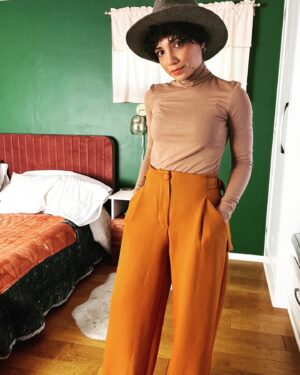 Jasika Nicole Instagram - These #MitchellTrousers by @closetcorepatterns are such a welcome addition to my pattern stash- I have a lot of great slim fit trousers in my arsenal but way less chic wide legged patterns to play around with and I absolutely love this cool, funky silhouette! I’m feeling a little Annie Hall pairing these pants with this hat (RTW from a leather and hat store in Santa Fe); if I just had a little vest to throw over this true bias turtleneck I would be set! The @wearethefabricstore fabric is 🥹🥹🥹 exceptional. It’s a heavyweight viscose twill in pumpkin and I’ve never sewn with anything quite like it. It somehow manages to be thick and squishy while also feeling floaty and hanging fluidly. You ever go to a really high end store or like, a Bloomingdale’s, and thumb through the really expensive garments and wonder “what the hell kind of fabric is this??” because it’s THAT luxurious? This is the fabric they are using lol. I would get it in every color if they had more! One important thing to know is that this fabric must be handled with care- despite its heaviness, it’s surprisingly delicate and it does not like lots of pin holes or the fabric will snag. It requires extra attention but these pants were worth every ounce of care I put into them. As always, the pattern is thoughtful with interesting details (the adjustable side ties!!!) and I can’t wait to make a lighter weigh pair for warmer months! Oh, and outfit also features my new fanny pack from @imadethatbag - I am over the moon in love with it and have used it every single day since I bought it. Lots of great styles, you can request different leather, the pouches are removable so you can choose different colors to match your fit, and it’s beautifully made- thrilled to spend money at a small woman owned business like Lorna’s! ❤️❤️❤️