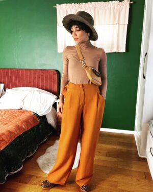 Jasika Nicole Instagram - These #MitchellTrousers by @closetcorepatterns are such a welcome addition to my pattern stash- I have a lot of great slim fit trousers in my arsenal but way less chic wide legged patterns to play around with and I absolutely love this cool, funky silhouette! I’m feeling a little Annie Hall pairing these pants with this hat (RTW from a leather and hat store in Santa Fe); if I just had a little vest to throw over this true bias turtleneck I would be set! The @wearethefabricstore fabric is 🥹🥹🥹 exceptional. It’s a heavyweight viscose twill in pumpkin and I’ve never sewn with anything quite like it. It somehow manages to be thick and squishy while also feeling floaty and hanging fluidly. You ever go to a really high end store or like, a Bloomingdale’s, and thumb through the really expensive garments and wonder “what the hell kind of fabric is this??” because it’s THAT luxurious? This is the fabric they are using lol. I would get it in every color if they had more! One important thing to know is that this fabric must be handled with care- despite its heaviness, it’s surprisingly delicate and it does not like lots of pin holes or the fabric will snag. It requires extra attention but these pants were worth every ounce of care I put into them. As always, the pattern is thoughtful with interesting details (the adjustable side ties!!!) and I can’t wait to make a lighter weigh pair for warmer months! Oh, and outfit also features my new fanny pack from @imadethatbag - I am over the moon in love with it and have used it every single day since I bought it. Lots of great styles, you can request different leather, the pouches are removable so you can choose different colors to match your fit, and it’s beautifully made- thrilled to spend money at a small woman owned business like Lorna’s! ❤️❤️❤️