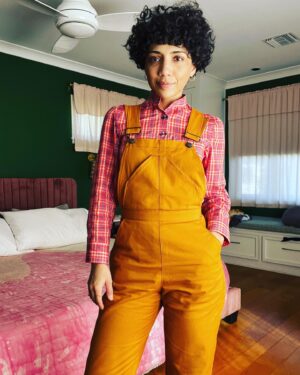 Jasika Nicole Instagram - Either my neck has grown since the last time I made this pattern or I somehow mixed up my pattern pieces and made it too tight to button the neck comfortably- regardless, I’m not really a Top Button Buttoner™️ so this has been a non-issue for me- I just left off the neck button and hole and voila 😂! I’ve also realized over the years that, though I love the tailored look of collared shirts, they have a tendency to make my neck disappear, while band collars make it look slightly longer, just a smidge more graceful. This is of course a personal preference- while I think pretty much all fashion “rules” are complete bologna, I think it’s also important to wear what makes you feel like a bad bitch, and band collars do just that. That’s not to say I won’t ever wear or make a standard collared shirt again, but I like having staple design details in my arsenal that I can always rely on to give me a fit that I love. I used TNT Butterick 5526 for this shirt which has several classic views included (I’m a big fan of the princess seam view too!) and I sized down to an 8 to avoid dealing with the all the weird excess ease. It fits perfectly in the body but again, I might need to adjust that neckline if I want a button at the top! I bought these buttons at some secondhand shop a while back and never imagined I would use them but they look so cool with this shirt- a nice pop of design. The plaid cotton voile in red/blue from @wearethefabricstore was delightful to sew- it’s very lightweight and floaty and has a bit of transparency to it but it doesn’t feel see-through at all- the graphic print does a good job of covering up what is underneath. It’s excellent both for layering in cooler months (as I’ve done here) and I plan to wear it alone in hotter climates because the fabric is just so breezy and breathable. And as my friend Cyndi told me, it’s the perfect bright red for the lunar new year! I’ve paired the shirt with my #jennyoveralls by @closetcorepatterns adjusted for a slim, straight leg.