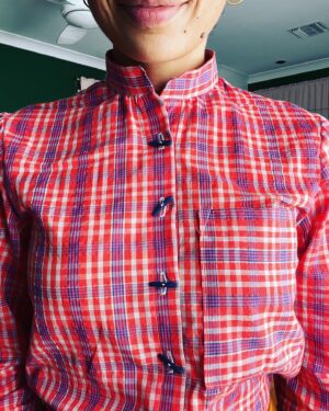Jasika Nicole Instagram - Either my neck has grown since the last time I made this pattern or I somehow mixed up my pattern pieces and made it too tight to button the neck comfortably- regardless, I’m not really a Top Button Buttoner™️ so this has been a non-issue for me- I just left off the neck button and hole and voila 😂! I’ve also realized over the years that, though I love the tailored look of collared shirts, they have a tendency to make my neck disappear, while band collars make it look slightly longer, just a smidge more graceful. This is of course a personal preference- while I think pretty much all fashion “rules” are complete bologna, I think it’s also important to wear what makes you feel like a bad bitch, and band collars do just that. That’s not to say I won’t ever wear or make a standard collared shirt again, but I like having staple design details in my arsenal that I can always rely on to give me a fit that I love. I used TNT Butterick 5526 for this shirt which has several classic views included (I’m a big fan of the princess seam view too!) and I sized down to an 8 to avoid dealing with the all the weird excess ease. It fits perfectly in the body but again, I might need to adjust that neckline if I want a button at the top! I bought these buttons at some secondhand shop a while back and never imagined I would use them but they look so cool with this shirt- a nice pop of design. The plaid cotton voile in red/blue from @wearethefabricstore was delightful to sew- it’s very lightweight and floaty and has a bit of transparency to it but it doesn’t feel see-through at all- the graphic print does a good job of covering up what is underneath. It’s excellent both for layering in cooler months (as I’ve done here) and I plan to wear it alone in hotter climates because the fabric is just so breezy and breathable. And as my friend Cyndi told me, it’s the perfect bright red for the lunar new year! I’ve paired the shirt with my #jennyoveralls by @closetcorepatterns adjusted for a slim, straight leg.