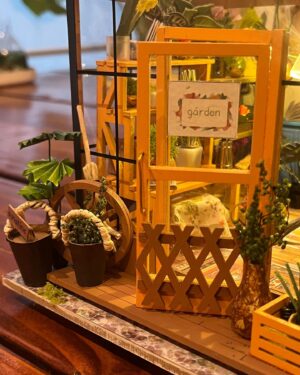 Jasika Nicole Instagram - My neighborhood besties @cyndiotteson and @quinnofeaglerock gifted me the cutest diy miniature room kit to put together last year, and I loved it so much I asked for a bigger kit for christmas, and at long last, only 9 months later 🥴, it’s finally done! This kit was like my personal equivalent of a 1,000 piece puzzle (though I’ve never done one so I don’t know how accurate that is). All I know is that it was extremely intense, required so much focus that I felt cross eyed at the end of some sessions, and required every bit of my concentration for long periods of time. However there were also so many moments of sheer delight along the way to completing this that it truly felt worth all the extra patience I mustered from the bowels of my being. I am so proud of myself! Bear got me an amazing magnifying craft light that was a tremendous help and allowed me to do really detailed work without straining my eyes too much (I also use it for my manis!) Every single thing in this greenhouse, with the exception of the wood framing pieces, beads and the “glass” roof, was cut out, pasted, sanded, shaped, built and glued together by hand. Those teeny flowers and petals, the shovel made out of a toothpick and paper, the garden hose and faucet, all created by hand. By the time I finished this I was so curious about the brains behind the designs! It’s truly remarkable work! I will definitely be taking a break from this intricate kind of craft for a while (I’ve got a beautiful crocheted lamp next up on my list!) but I would love to do another kit one day- @rolife_official has so many beautiful designs but I obviously wanna make the dressmaker’s boutique and one of the bakery/kitchen builds, too. Truly can’t explain how much delight this piece has given me, and now I think I might build some floating shelves to really show these pieces off!