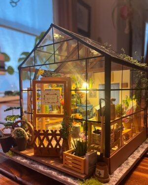 Jasika Nicole Instagram - My neighborhood besties @cyndiotteson and @quinnofeaglerock gifted me the cutest diy miniature room kit to put together last year, and I loved it so much I asked for a bigger kit for christmas, and at long last, only 9 months later 🥴, it’s finally done! This kit was like my personal equivalent of a 1,000 piece puzzle (though I’ve never done one so I don’t know how accurate that is). All I know is that it was extremely intense, required so much focus that I felt cross eyed at the end of some sessions, and required every bit of my concentration for long periods of time. However there were also so many moments of sheer delight along the way to completing this that it truly felt worth all the extra patience I mustered from the bowels of my being. I am so proud of myself! Bear got me an amazing magnifying craft light that was a tremendous help and allowed me to do really detailed work without straining my eyes too much (I also use it for my manis!) Every single thing in this greenhouse, with the exception of the wood framing pieces, beads and the “glass” roof, was cut out, pasted, sanded, shaped, built and glued together by hand. Those teeny flowers and petals, the shovel made out of a toothpick and paper, the garden hose and faucet, all created by hand. By the time I finished this I was so curious about the brains behind the designs! It’s truly remarkable work! I will definitely be taking a break from this intricate kind of craft for a while (I’ve got a beautiful crocheted lamp next up on my list!) but I would love to do another kit one day- @rolife_official has so many beautiful designs but I obviously wanna make the dressmaker’s boutique and one of the bakery/kitchen builds, too. Truly can’t explain how much delight this piece has given me, and now I think I might build some floating shelves to really show these pieces off!