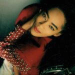 Jody Watley Instagram – #tbt 💋 1988 in Burgundy studded sleeves Jean Paul-Gaultier Bolero & jeans – I’m not sure who the photographer was /is 😞 

#jodywatley #jeanpaulgaultier #jpg #brows #redlipstick💄 #wingedliner #jodywatleystyle