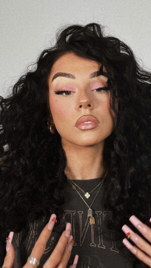 Jordan Lipscombe Instagram - C U R L Y  H A I R  T U T O R I A L 

products used: 
@markhillhair pick & mix corkscrew wand
@redken heat protectant 
@beauty_worksonline hair oil 
@geehair hair extensions 

tips:
• tie hair up at nape of neck to avoid short hair showing 
• the more hair the better 
• tease the hair at the crown of the head to thicken the hair up so you can get a hair piece as high as possible without showing 
• wiggle the extension clip into the root before clipping for grip
• pull apart curls for volume 
• twist some pieces of real hair into a hair extension curl 
• alternate direction of curls for volume 
• curl from the root for a natural curl look
• oil for shine and hairspray for hold to finish